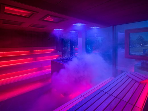 Sie suchen ein Wellnesshotel in Tirol für adults only? Moderne Sauna mit roter und blauer Beleuchtung und Dampf